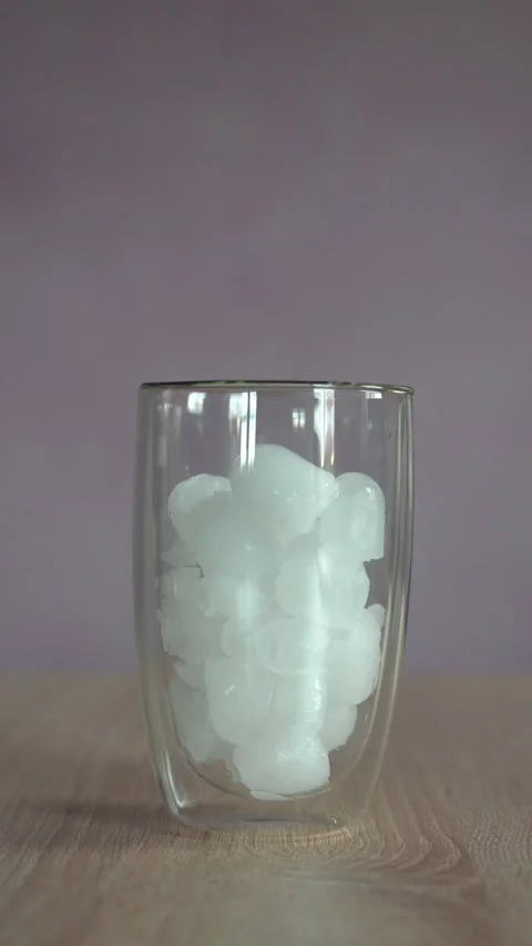 Ice cubes and water being poured into glass Stock Footage 229652233