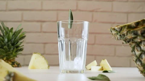 Ice cubes are added to the pineapple cocktail, pina colada drink is made Stock Footage 178481867
