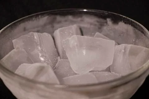 Ice cubes. Black background. Cold. Frozen. Water droplets. White and black. Stock Photos