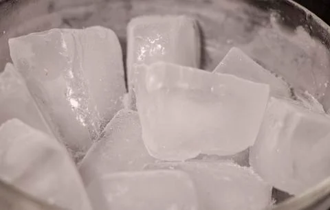 Ice cubes. Black background. Cold. Frozen. Water droplets. White and black. Stock Photos