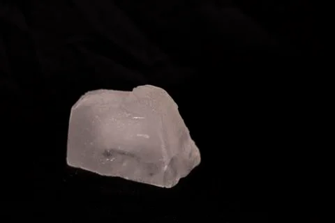 Ice cubes. Black background. Cold. Frozen. Water droplets. White and black. Stock Photos