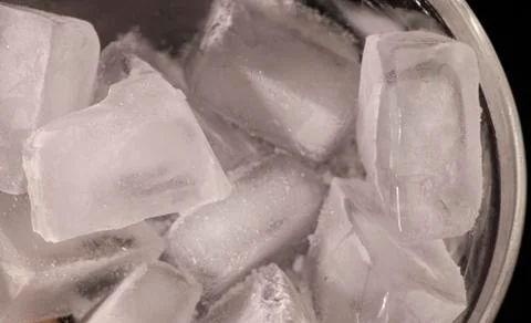 Ice cubes. Black background. Cold. Frozen. Water droplets. White and black. Stock Photos