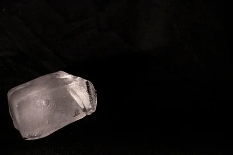 Ice cubes. Black background. Cold. Frozen. Water droplets. White and black. Stock Photos
