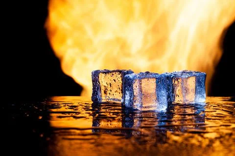 Ice cubes on a black background in flames Stock Photos