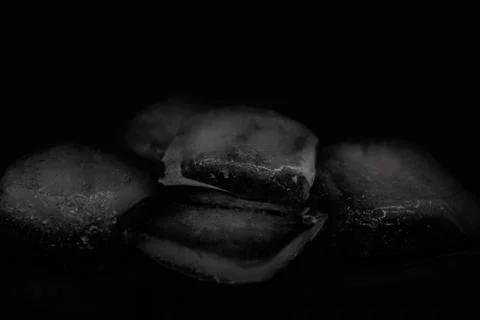 Ice cubes on a black background Stock Photos