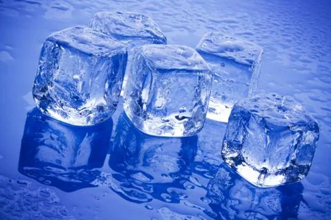 Ice cubes in blue background Stock Photos