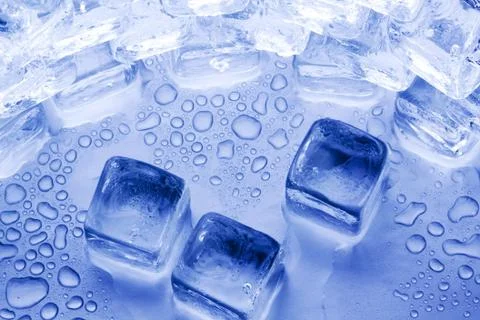 Ice cubes in blue background Stock Photos