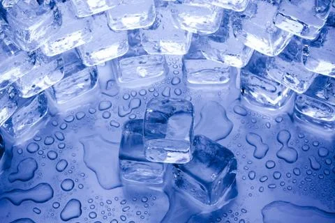 Ice cubes in blue background Stock Photos