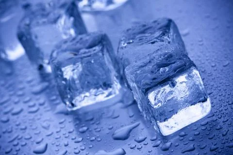Ice cubes in blue background Stock Photos
