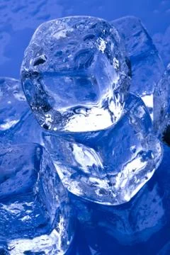 Ice cubes in blue background Stock Photos