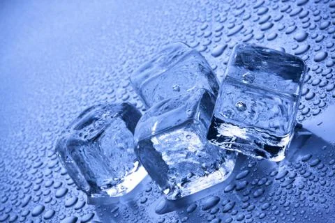 Ice cubes in blue background Stock Photos