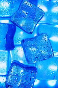 Ice cubes with blue backlight in the freezer close-up in full screen Stock Photos