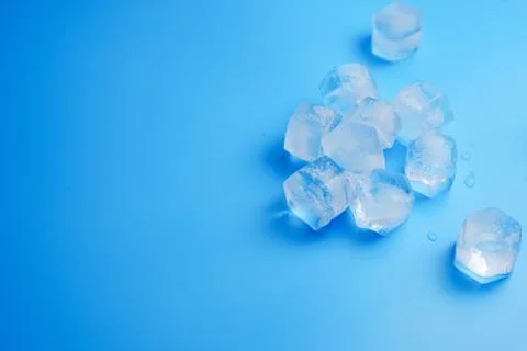 Ice cubes on a blue. Stock Photos