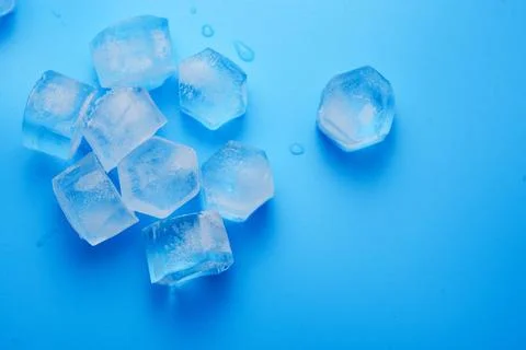 Ice cubes on a blue. Stock Photos