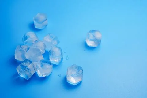 Ice cubes on a blue. Stock Photos