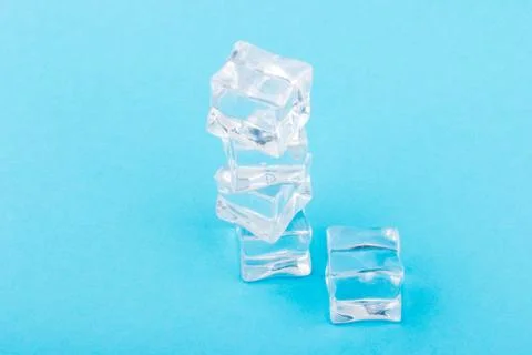 Ice cubes in close-up on blue background Stock Photos