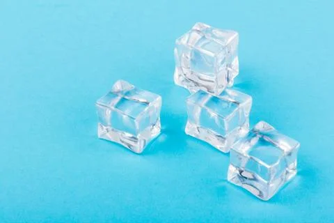 Ice cubes in close-up on blue background Foto stock