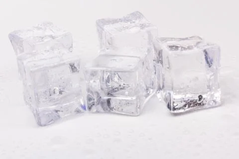Ice cubes in close-up on gray background Stock Photos