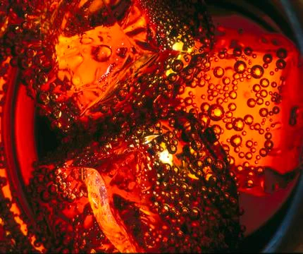 Ice cubes in cola beverage, close up Stock Photos