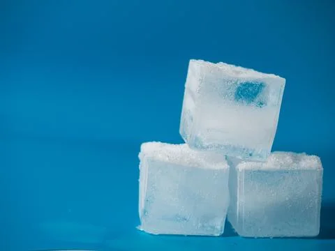 Ice cubes cold blue background Stock Photos