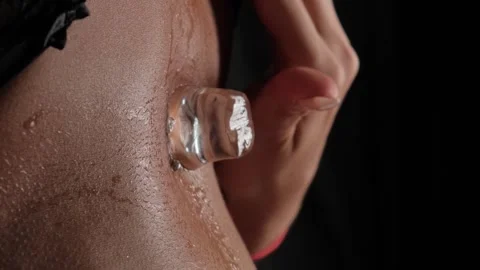 Ice cubes fall on a beautiful female body in black panties. Slow motion Stock Footage 254954913