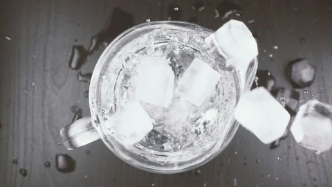 Ice cubes fall into a carafe with water Stock Footage 87652533