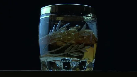 Ice cubes fall into cognac Stock Footage 81271196
