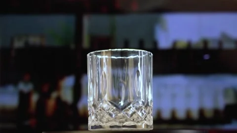 Ice Cubes Fall into Decorative Whisky Glass Stock Footage 143165343