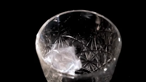 Ice cubes fall into a glass Stock Footage 105751099