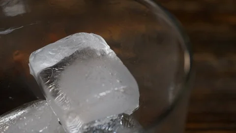 Ice cubes fall into a glass Stock Footage 123899733