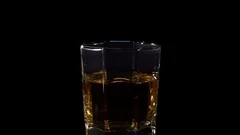 Ice cube falling into whisky glass – License Images – 11039807 ❘ StockFood