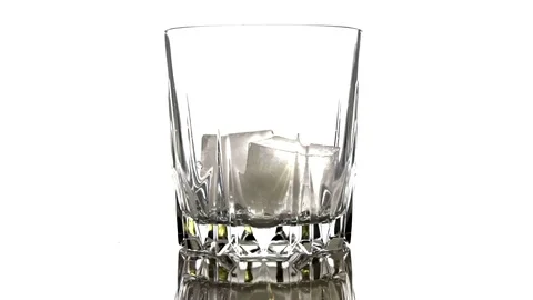 Ice cubes fall into a glass on white background. Slow motion. Cocktail concep 스톡 동영상 125339031
