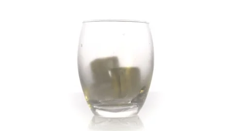 Ice cubes fall into a glass on white background. Slow motion. Cocktail concep Stock Footage 125379450
