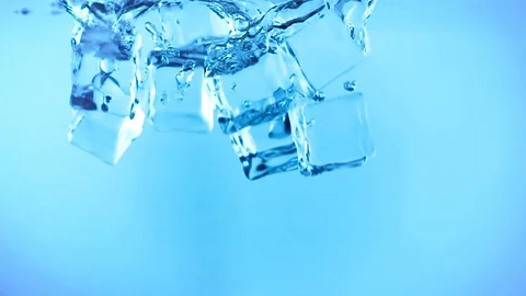 Ice cubes fall into the water. Ice underwater. Frozen water in form of a cube Stock Footage 95072355