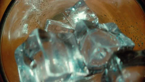 Ice Cubes Falling into a Clear Glass for a Refreshing Drink Beverage Concept 库存影片 331098982