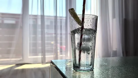 Ice Cubes Falling Into Cold Glass Of Water With Lemon Droplets Condensation Stock Footage 340332672