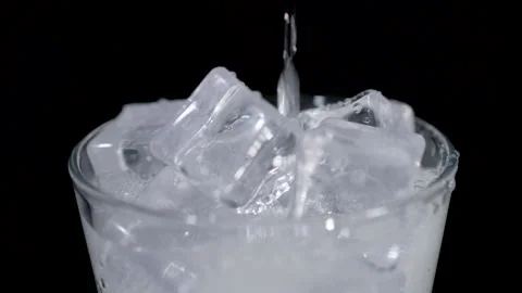Ice Cubes Falling into Dark Glass Drink Close Up Stock Footage 340123825