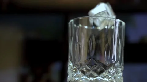 Ice Cubes Falling into Decorative Whisky Glass Stock Footage 143165330