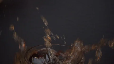 Ice cubes falling into glas of Coca Cola wide macro Video stock 124018439