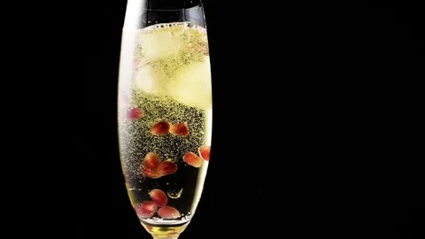 Ice cubes falling into a glass of champagne Video stock 72535343
