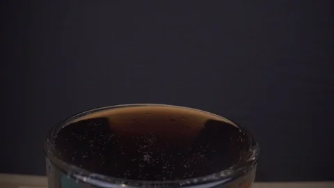 Ice cubes falling into Glass of Coca-Cola in slowmotion Stock Footage 124018370
