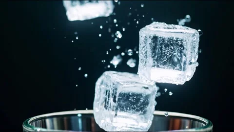 Ice Cubes Falling into Glass: A Refreshing Drink on a Dark Background Stock Footage 300281575
