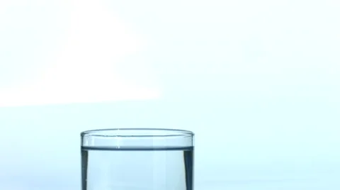 Ice cubes falling into glass of water Stock-Footage 61665653