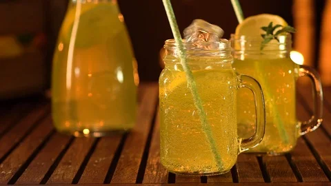 Ice cubes falling in slow-motion in fresh homemade lemonade Stock Footage 93634294
