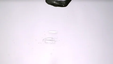 Ice Cubes falling, splitting, breaking up into white background Video stock 104633488