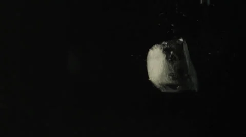 Ice cubes falling in water Stock Footage 24896869