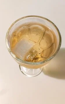 Ice cubes float in a vibrant tropical beverage. Coolness and summer enjoyment 스톡 사진