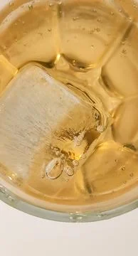 Ice cubes float in a vibrant tropical beverage. Coolness and summer enjoyment 스톡 사진