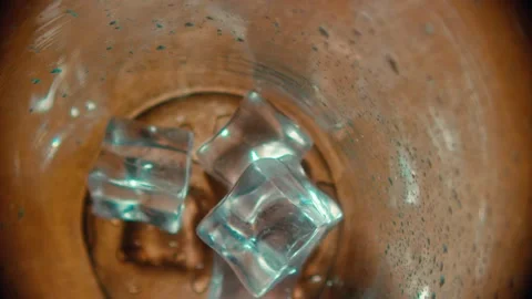 Ice Cubes Floating Inside a Clear Glass of Water with Condensation Droplets Stockbeeldmateriaal 331098994