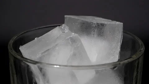 Ice cubes in a glass on a black background. Stock Footage 148030450